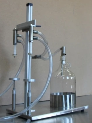 A standard benchtop vacuum filler used to fill perfumes and other cosmetics
